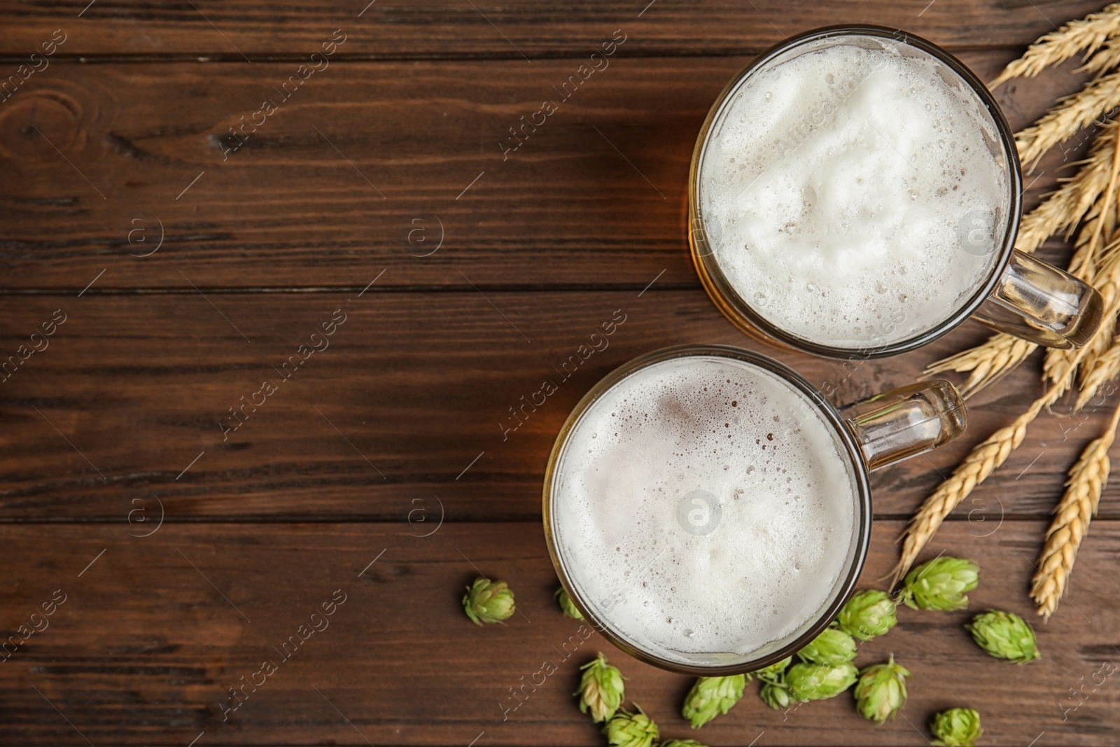 Photo of Flat lay composition with tasty beer and fresh green hops on wooden background. Space for text