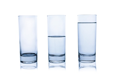 Empty, half and full glasses of water on white background