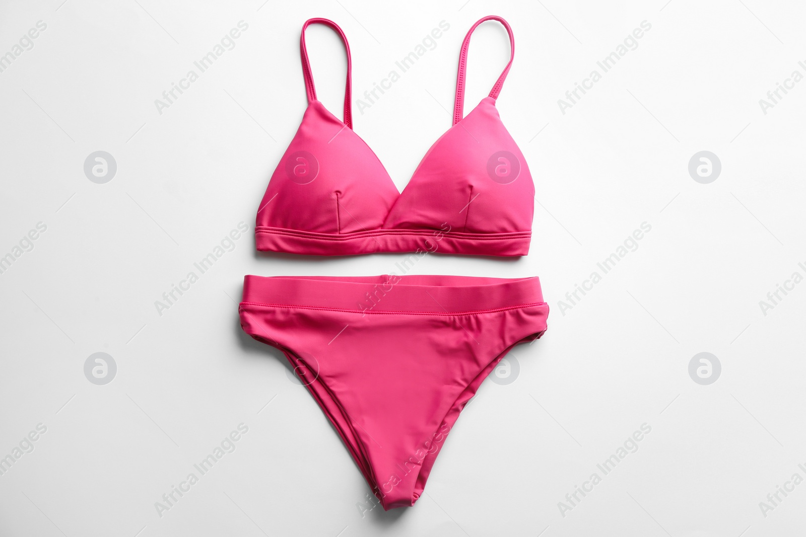 Photo of Beautiful pink bikini on white background, top view