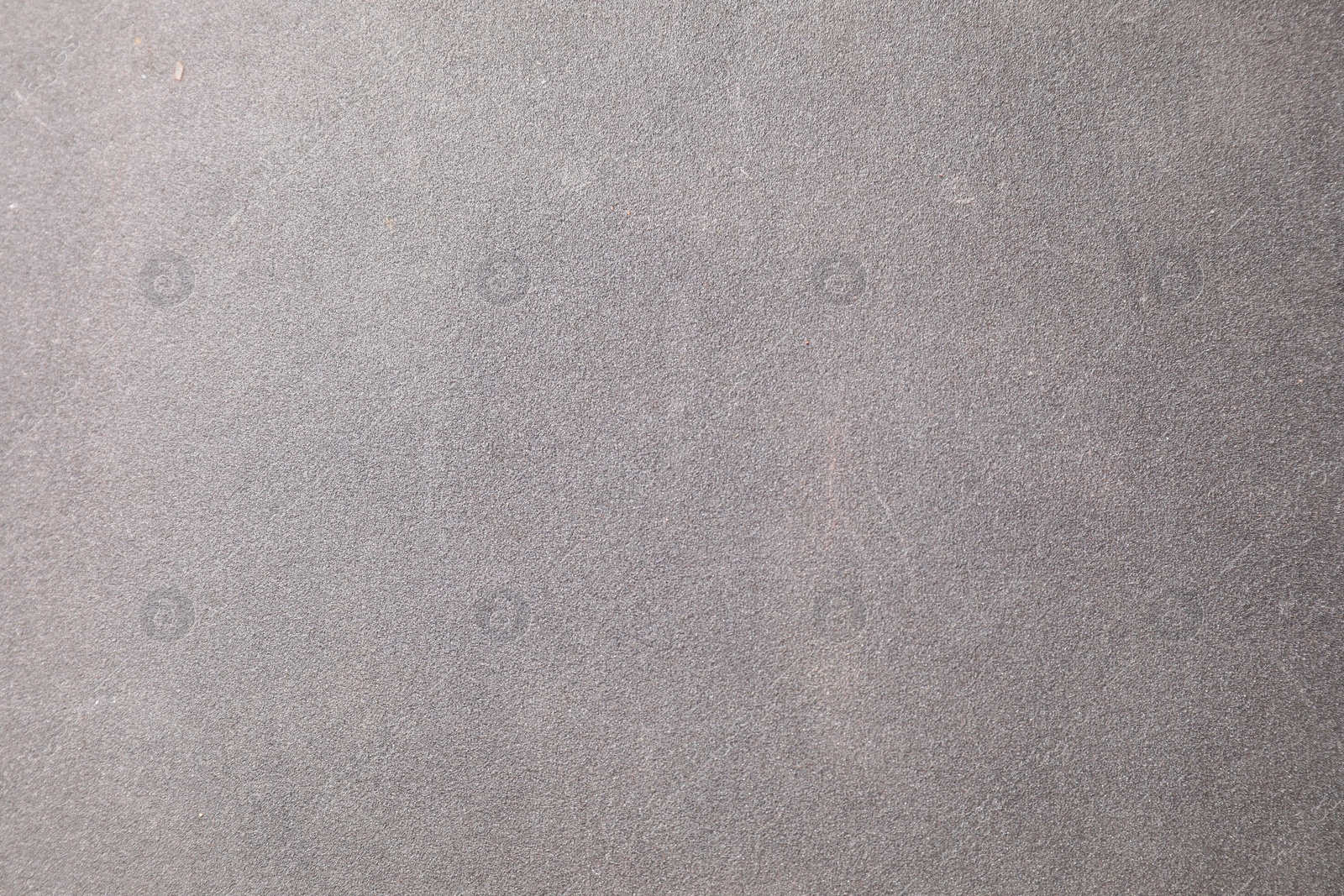 Photo of Texture of coarse sandpaper as background, top view