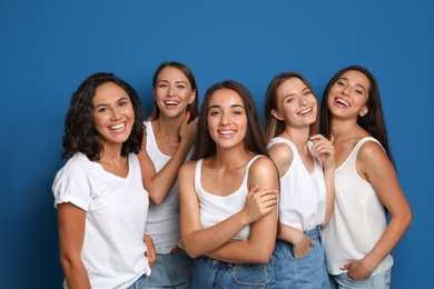 Photo of Happy women on blue background. Girl power concept