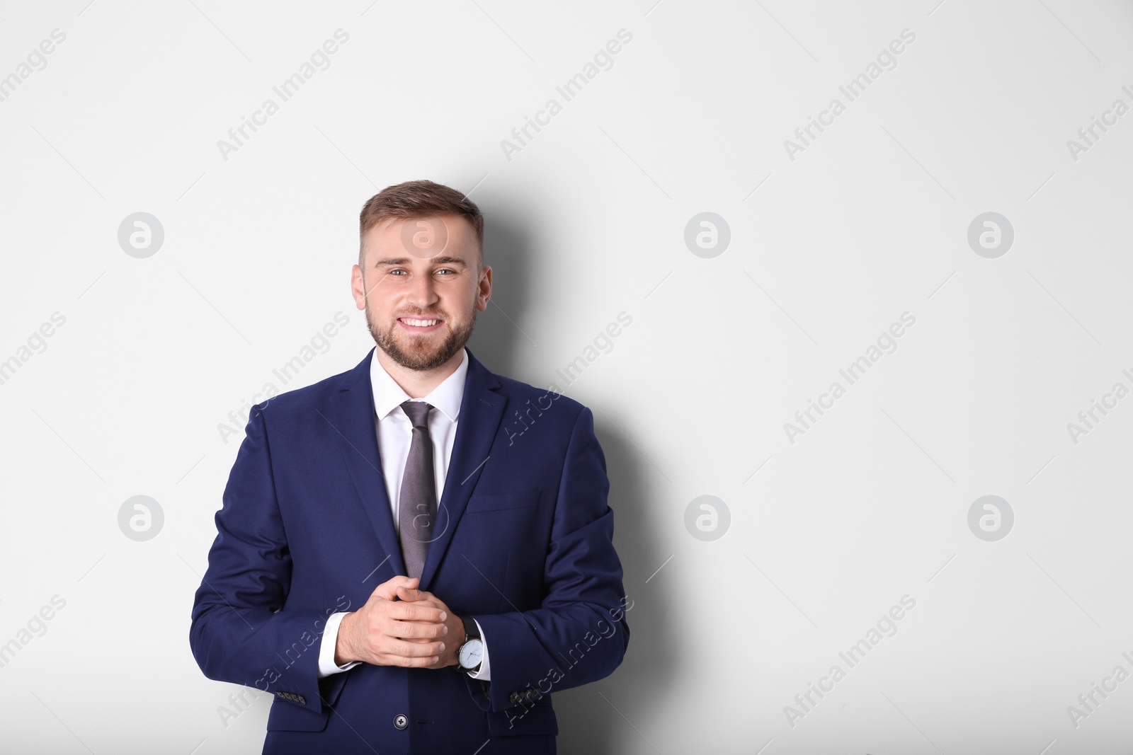 Photo of Portrait of happy man in office suit on white background