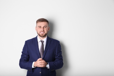 Portrait of happy man in office suit on white background