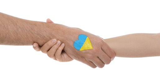 Photo of Man and woman with painted heart in colors of Ukrainian flag on her hand against white background, closeup