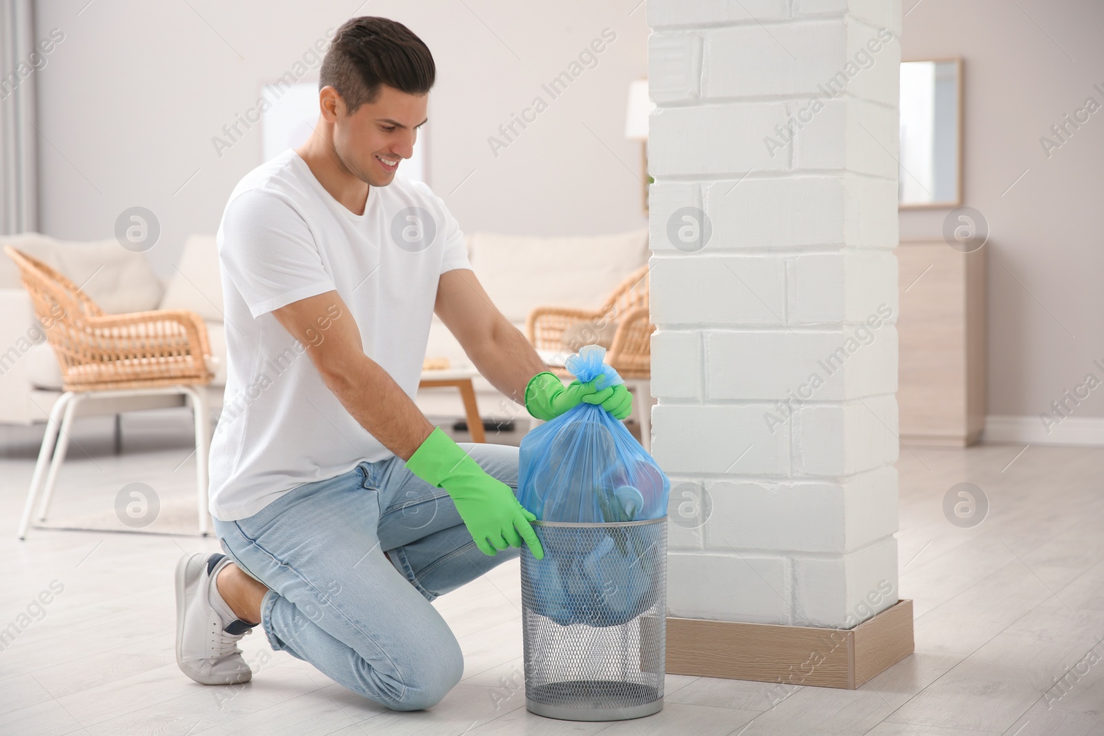 Photo of Man taking garbage bag out of bin at home