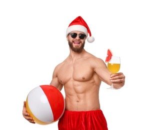 Photo of Muscular young man in Santa hat with ball and cocktail on white background