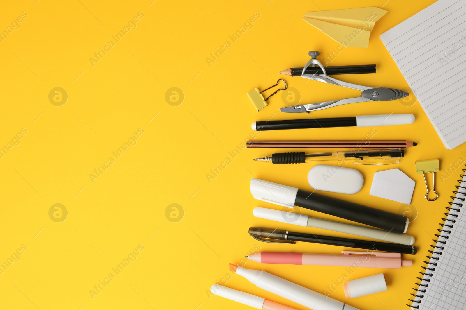Photo of Flat lay composition with paper plane and different school stationery on orange background, space for text. Back to school