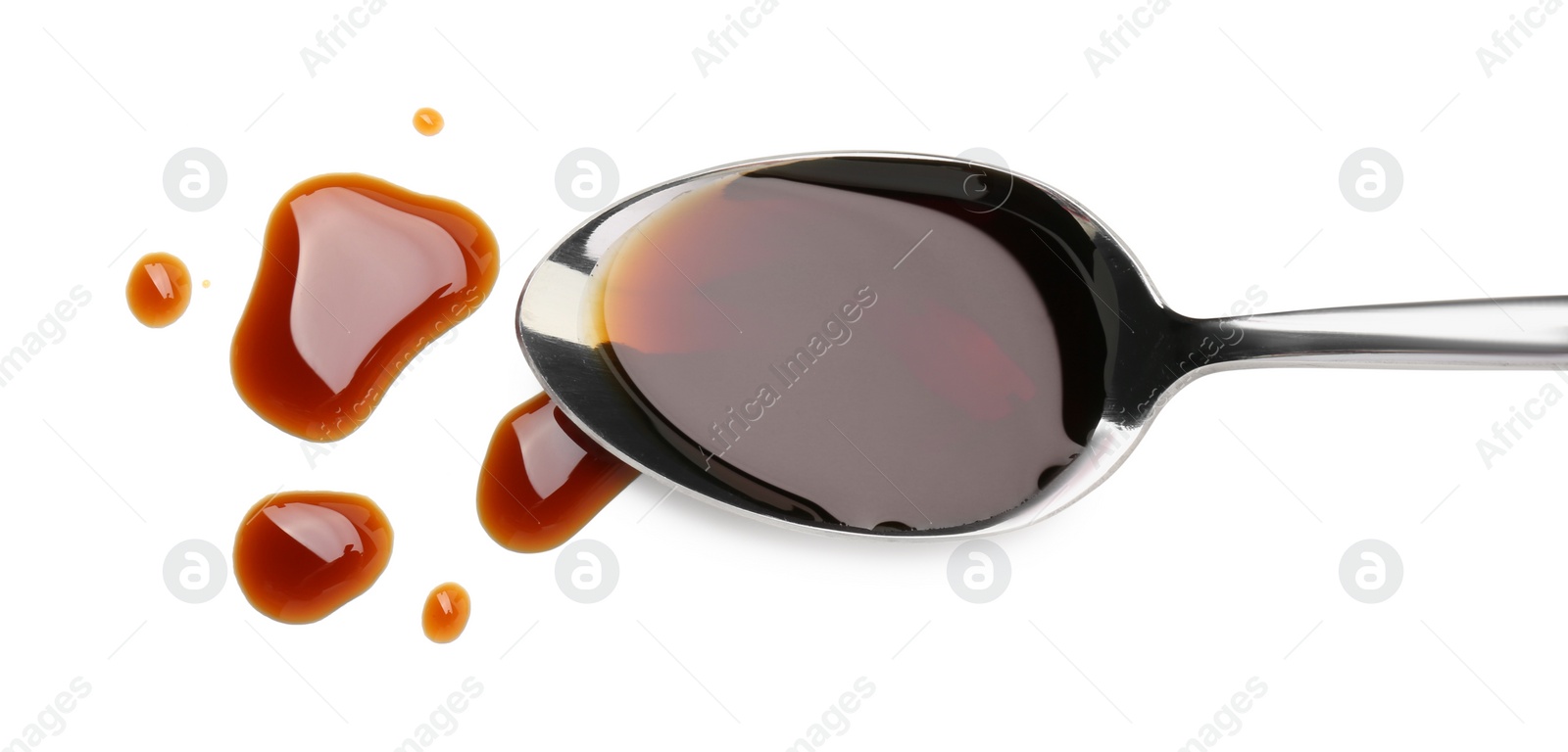 Photo of Tasty soy sauce in spoon isolated on white, top view