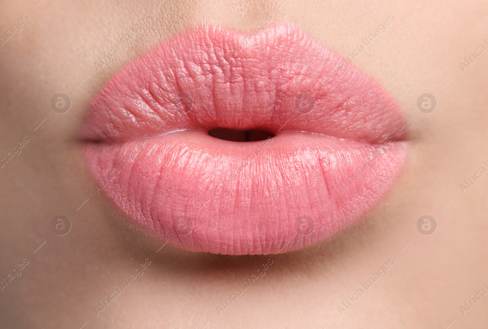 Photo of Closeup view of beautiful woman puckering lips for kiss