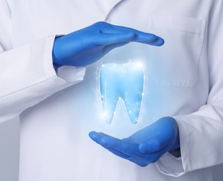Image of Dentist demonstrating virtual model of healthy tooth, closeup