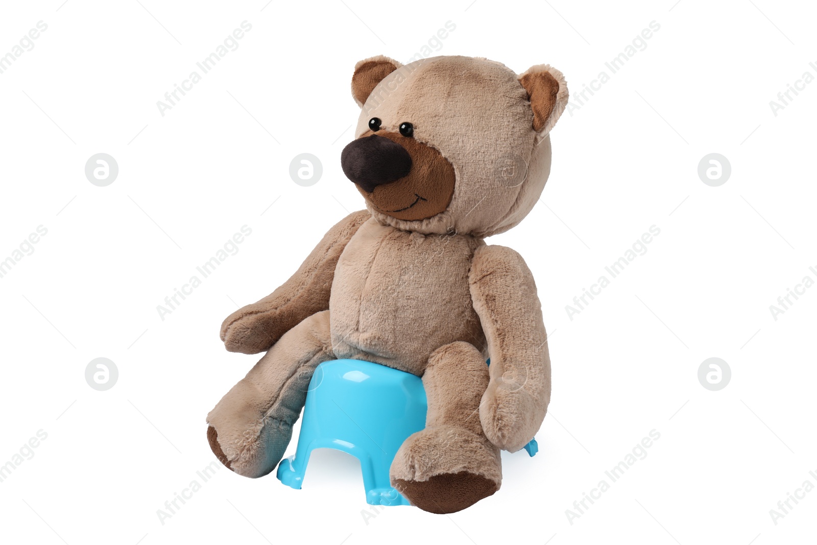 Photo of Teddy bear on light blue baby potty isolated on white. Toilet training