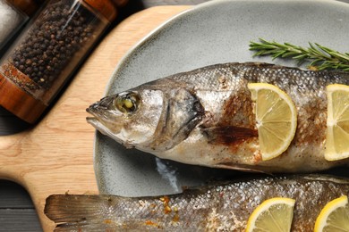 Photo of Delicious baked fish served on table, top view