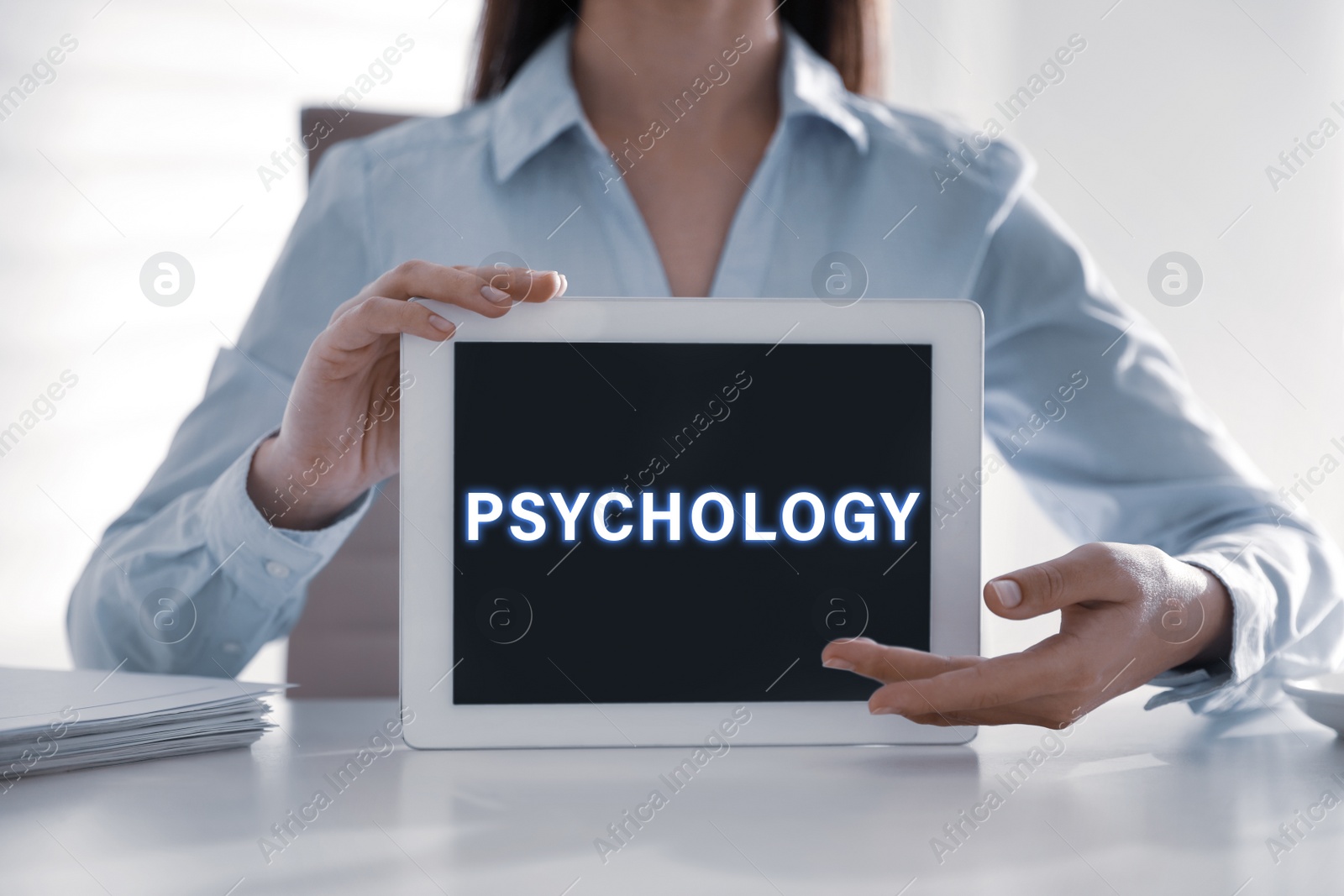 Image of Psychologist with modern tablet at white table in office, closeup 