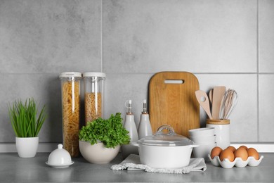 Set of different cooking utensils and products on grey countertop in kitchen