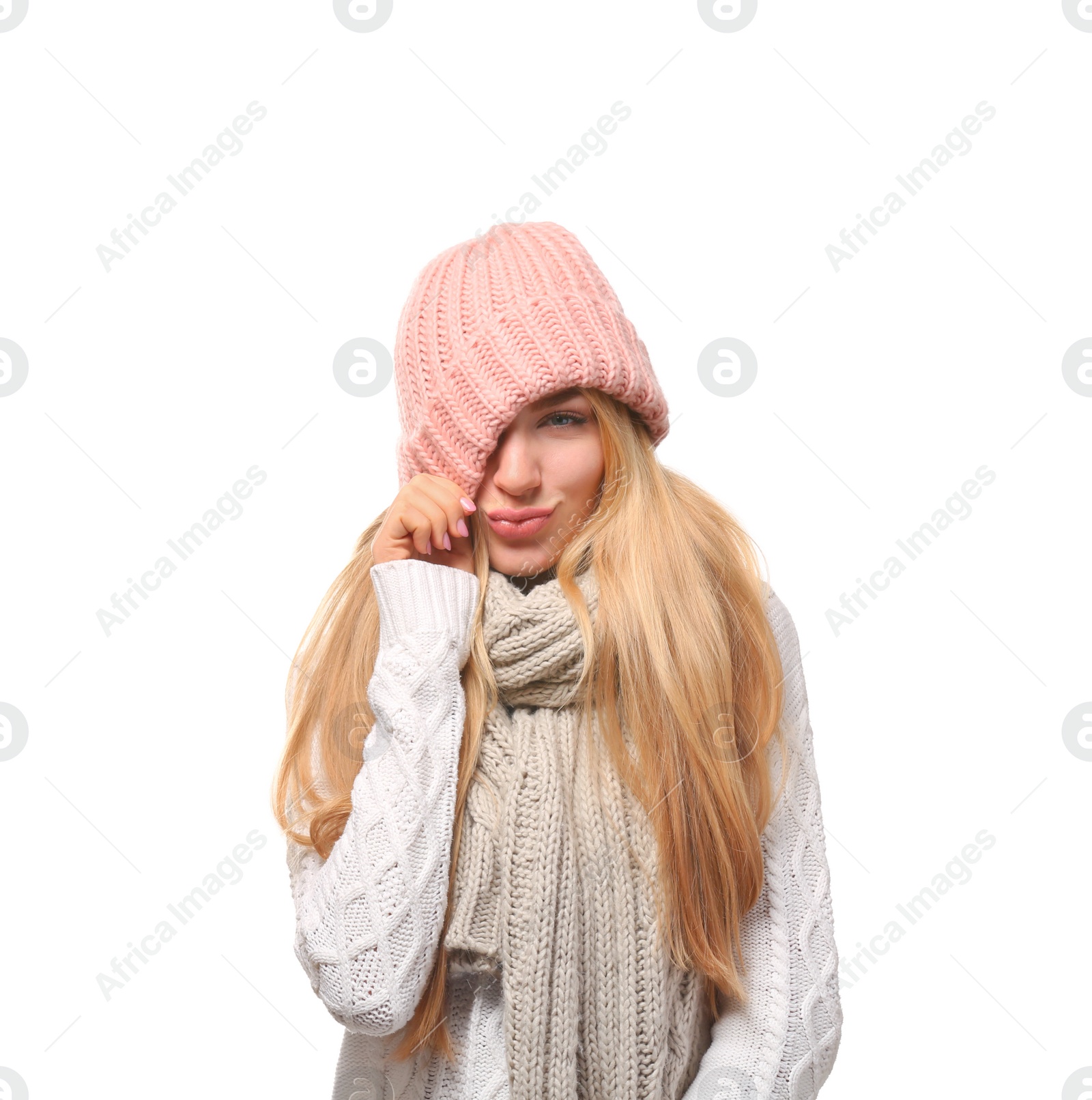 Photo of Portrait of emotional young woman in stylish hat and sweater with scarf on white background. Winter atmosphere