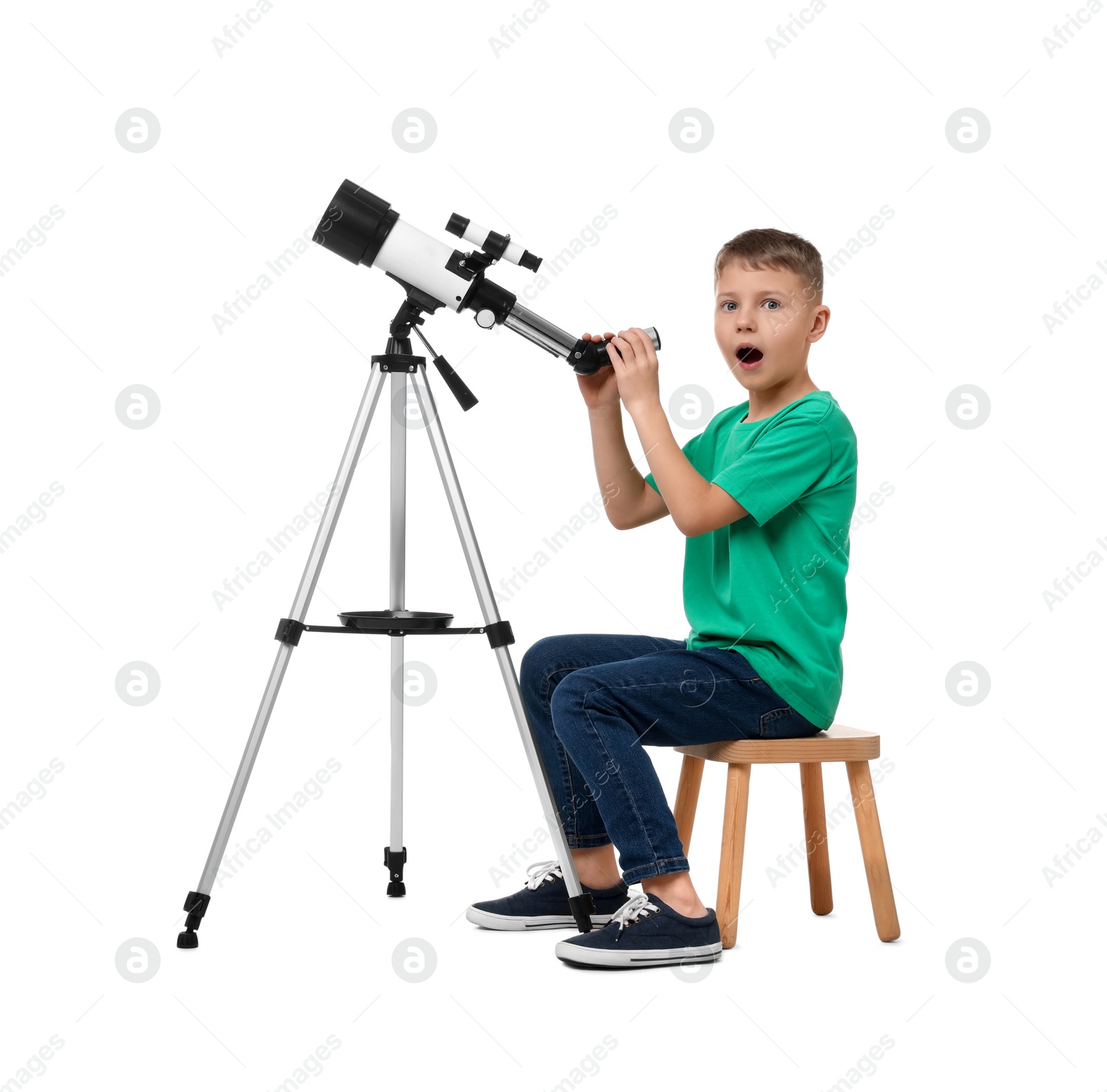 Photo of Surprised little boy with telescope on white background
