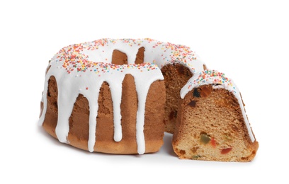 Glazed Easter cake with sprinkles and candied fruits on white background