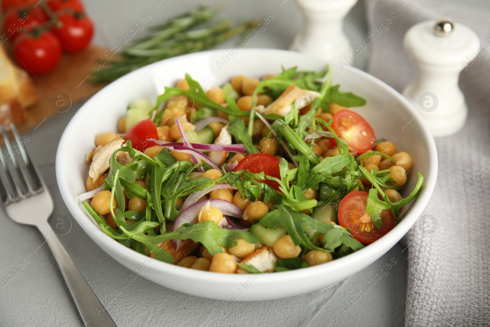Photo of Delicious fresh chickpea salad on light grey table