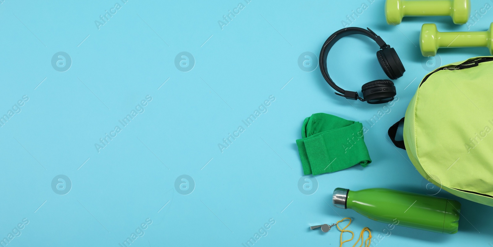 Photo of Different sports equipment on light blue background, flat lay. Space for text