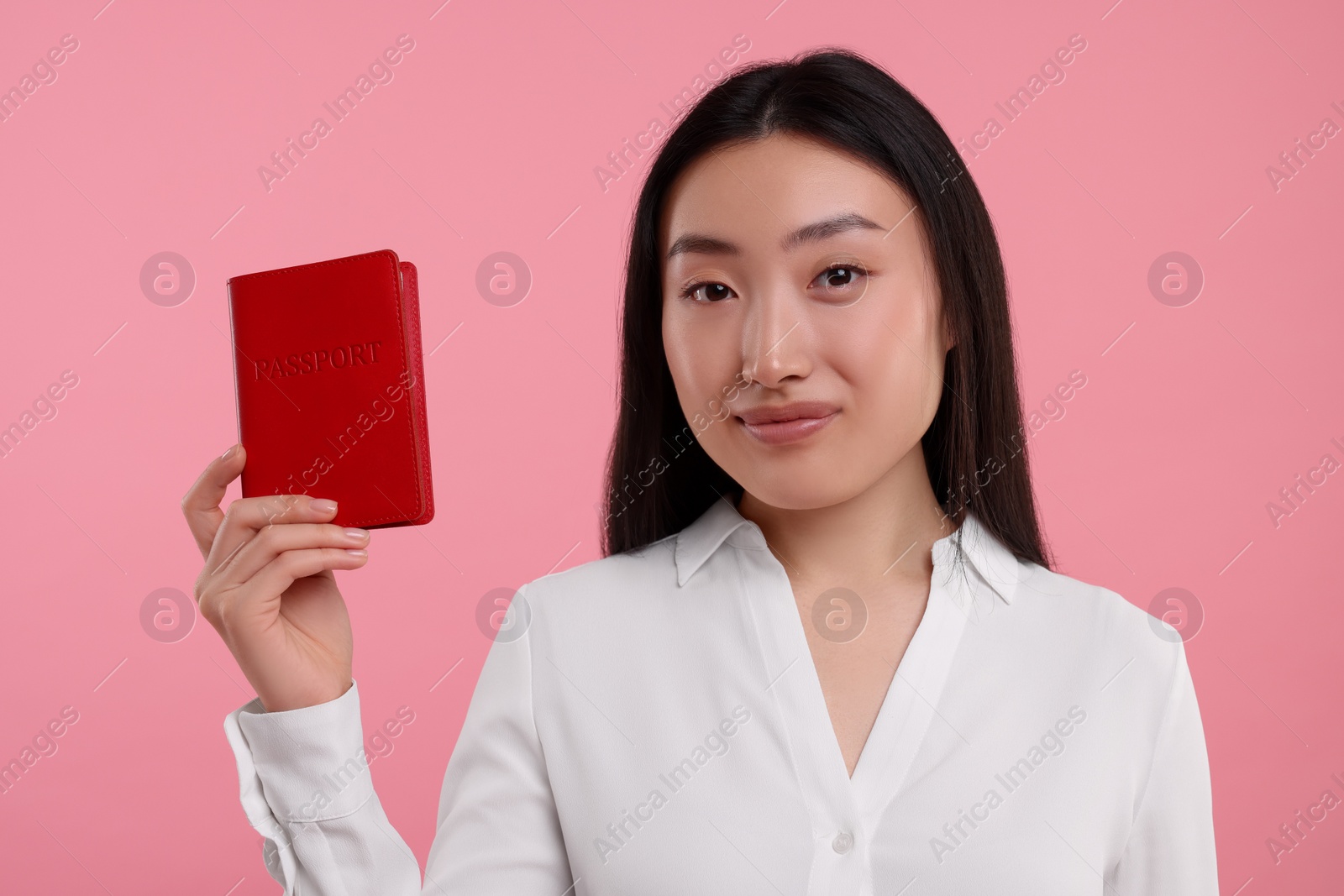 Photo of Immigration. Woman with passport on pink background