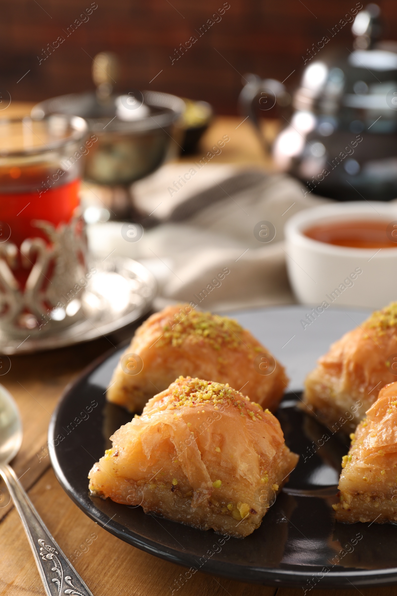 Photo of Delicious sweet baklava with pistachios on table, closeup