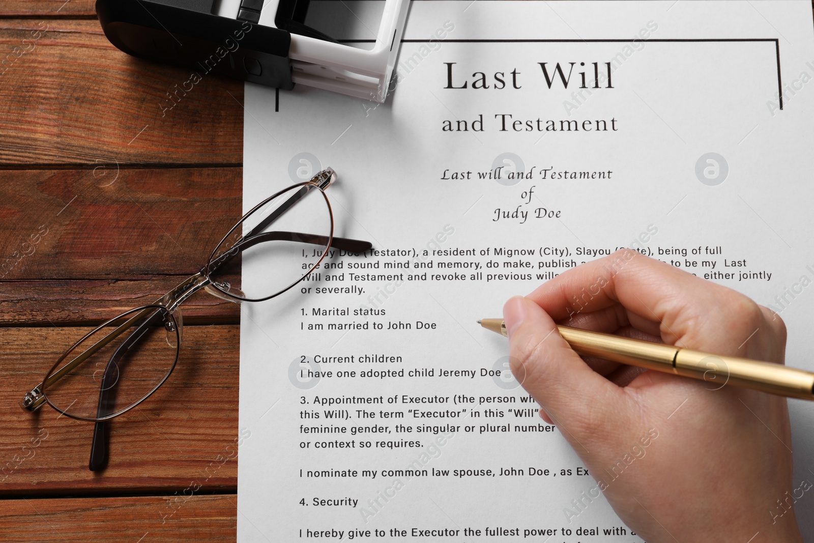 Photo of Woman signing Last Will and Testament at wooden table, above view