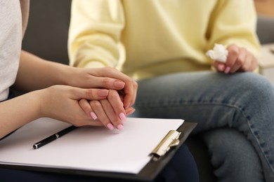 Photo of Professional psychotherapist working with patient in office, closeup