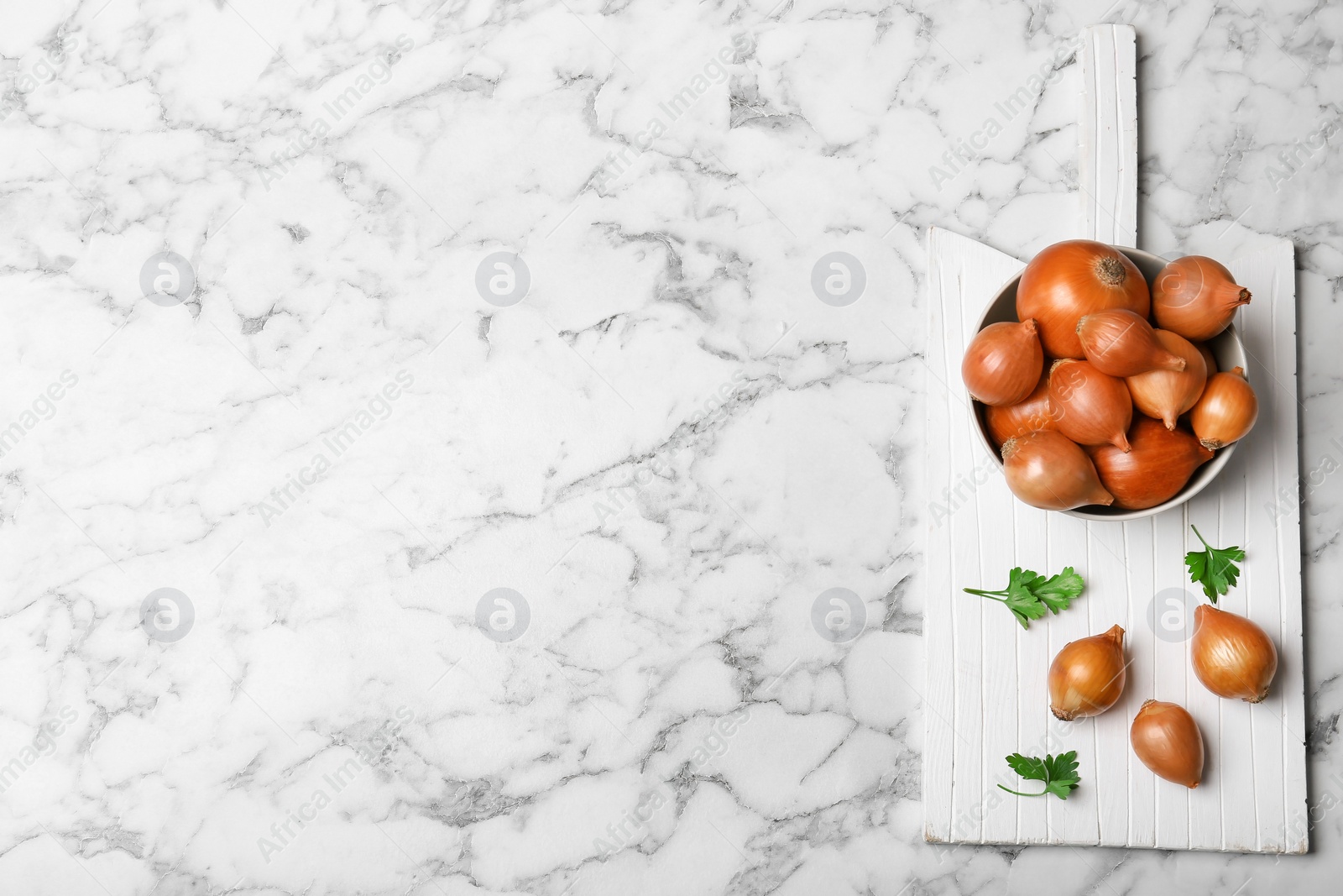 Photo of Flat lay composition with fresh ripe onions on marble table