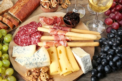 Photo of Composition with wine and snacks on wooden background
