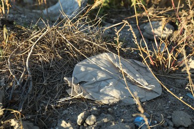 Photo of Different plastic garbage outdoors. Environmental pollution concept