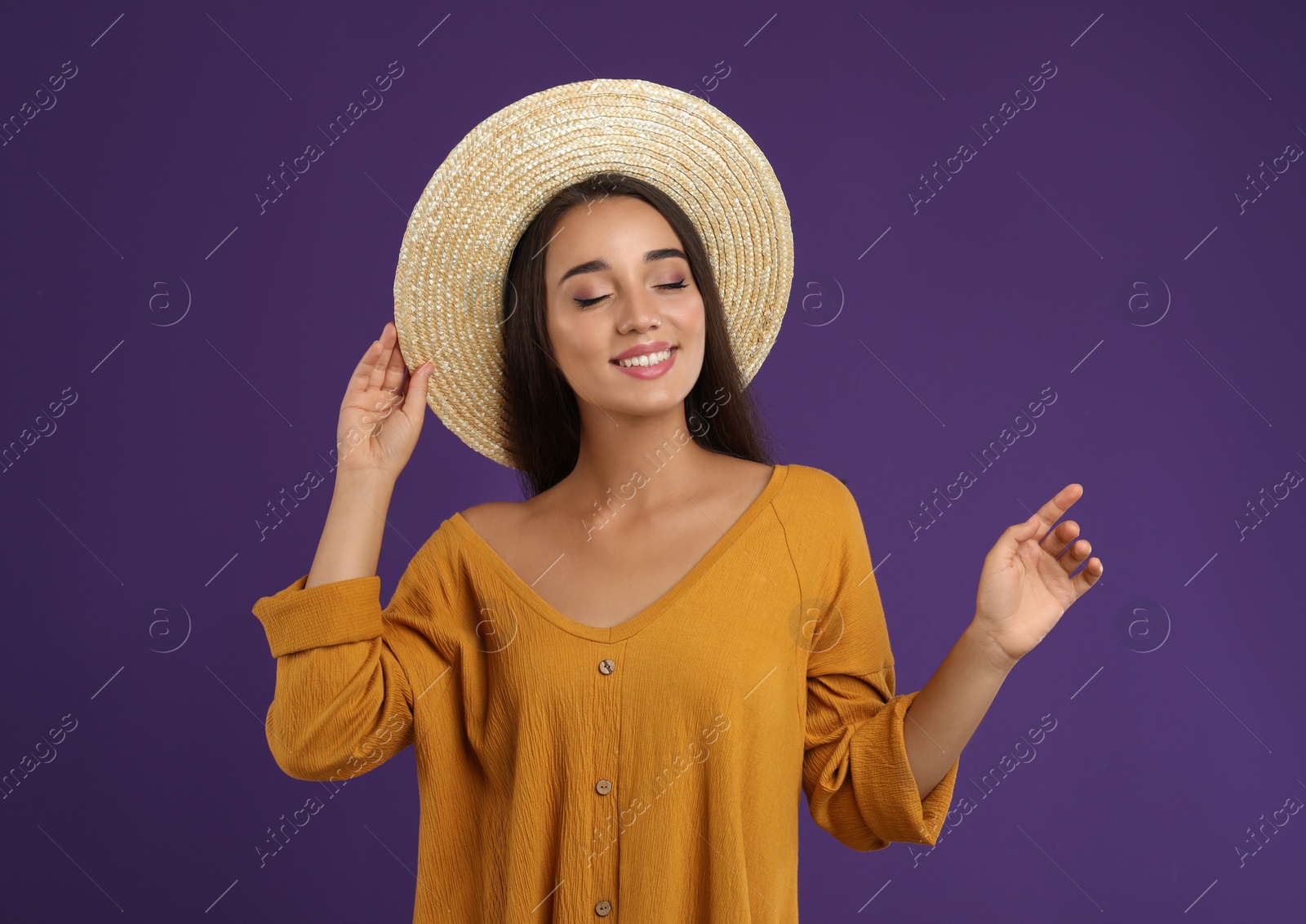 Photo of Young woman wearing stylish dress on purple background