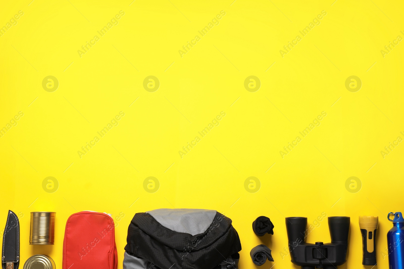 Photo of Flat lay composition with different camping equipment on color background, space for text