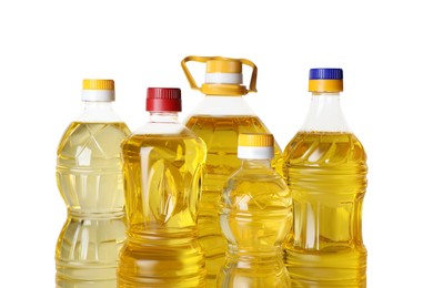 Photo of Bottles of cooking oil on white background