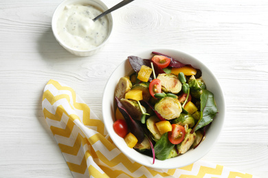 Photo of Delicious salad with roasted Brussels sprouts on white wooden table, flat lay