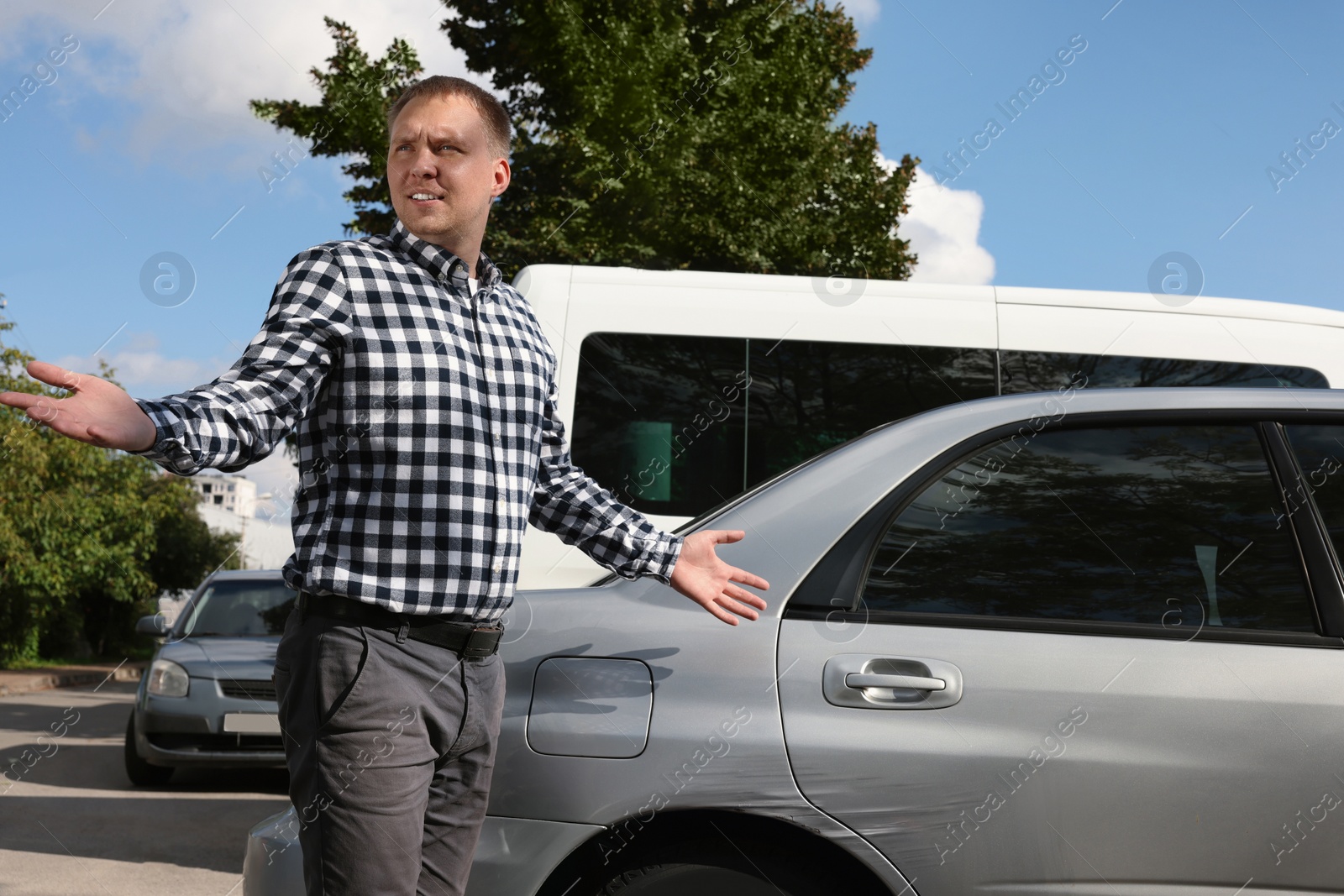 Photo of Stressed man near car with scratch outdoors