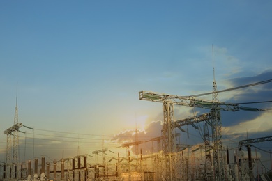 Photo of Modern electrical substation against cloudy sky at sunset