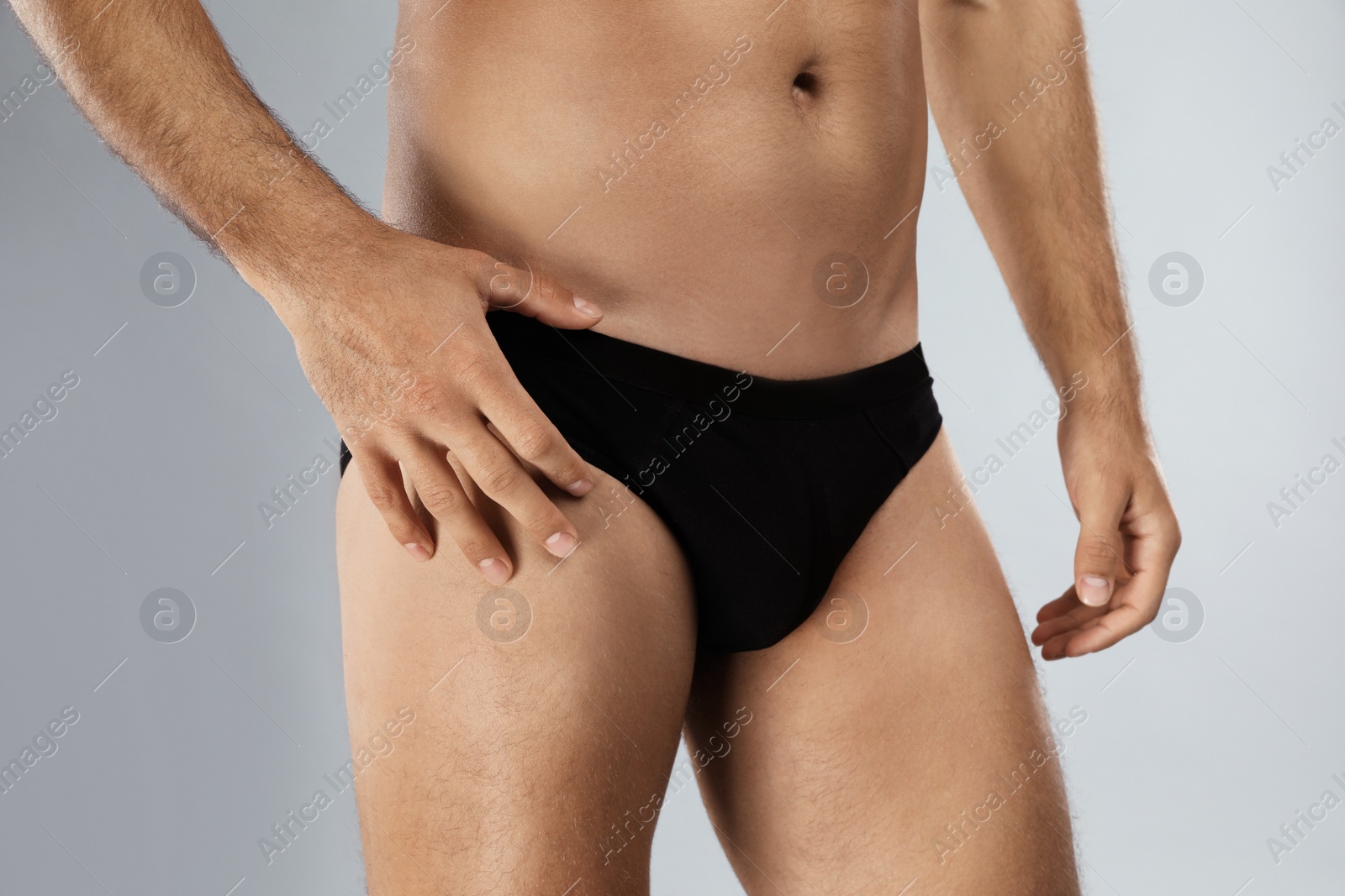 Photo of Man in black underwear on light grey background, closeup