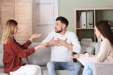 Family psychologist working with young couple in office