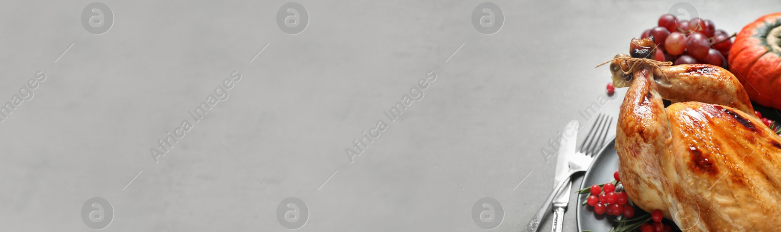 Image of Tasty turkey served on grey table, space for text. Banner design