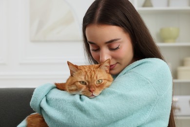 Photo of Beautiful woman with cute cat at home
