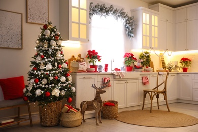 Beautiful kitchen interior with Christmas tree and festive decor