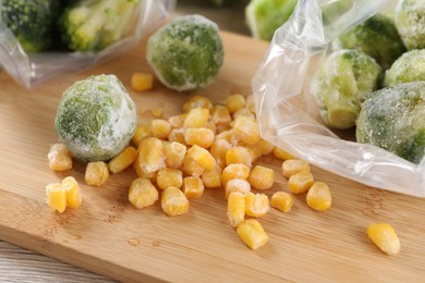 Photo of Frozen vegetables on wooden table, closeup view