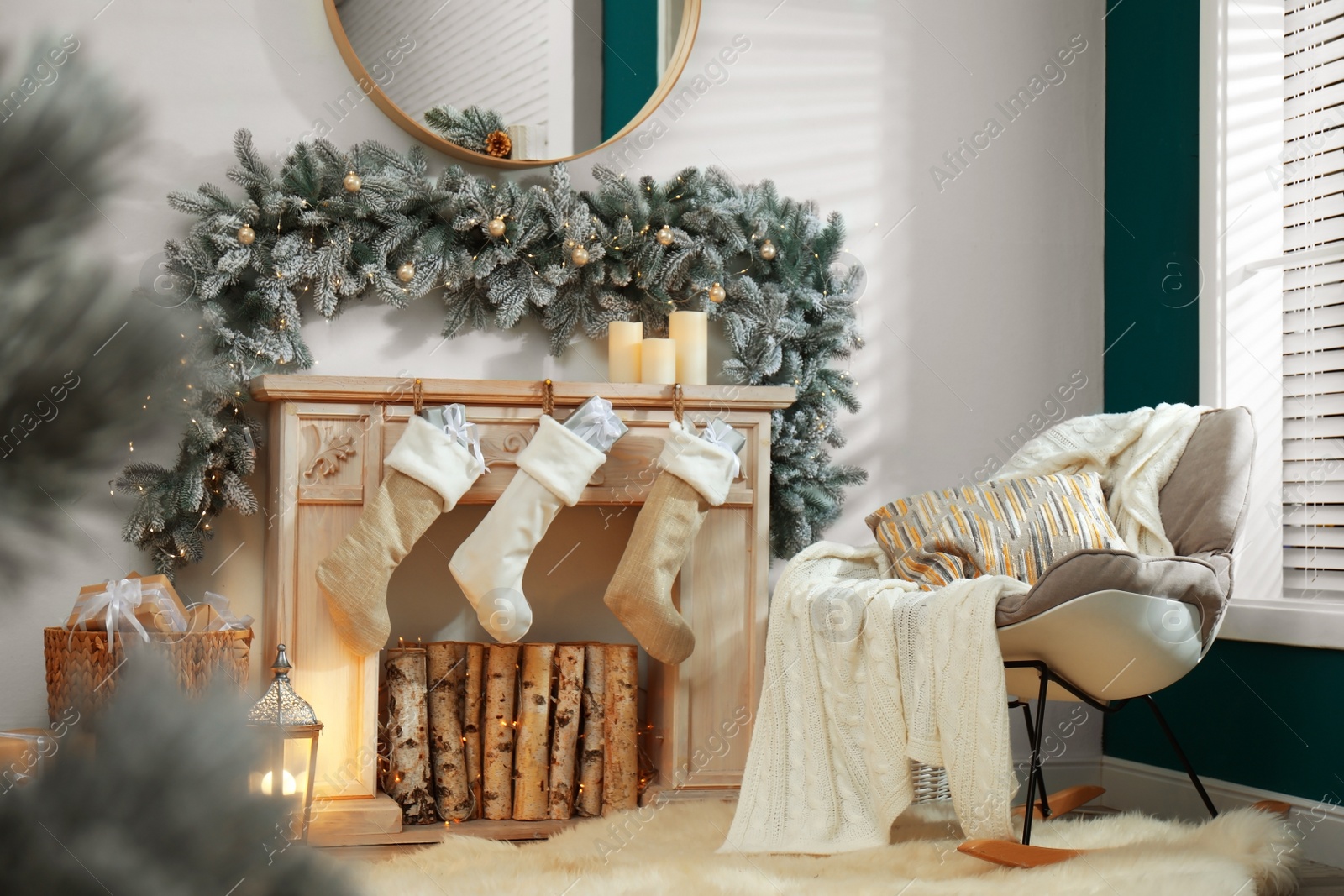 Photo of Fireplace with Christmas stockings in festive room interior