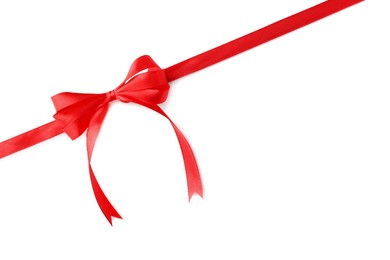 Photo of Red bow and ribbon on white background, top view