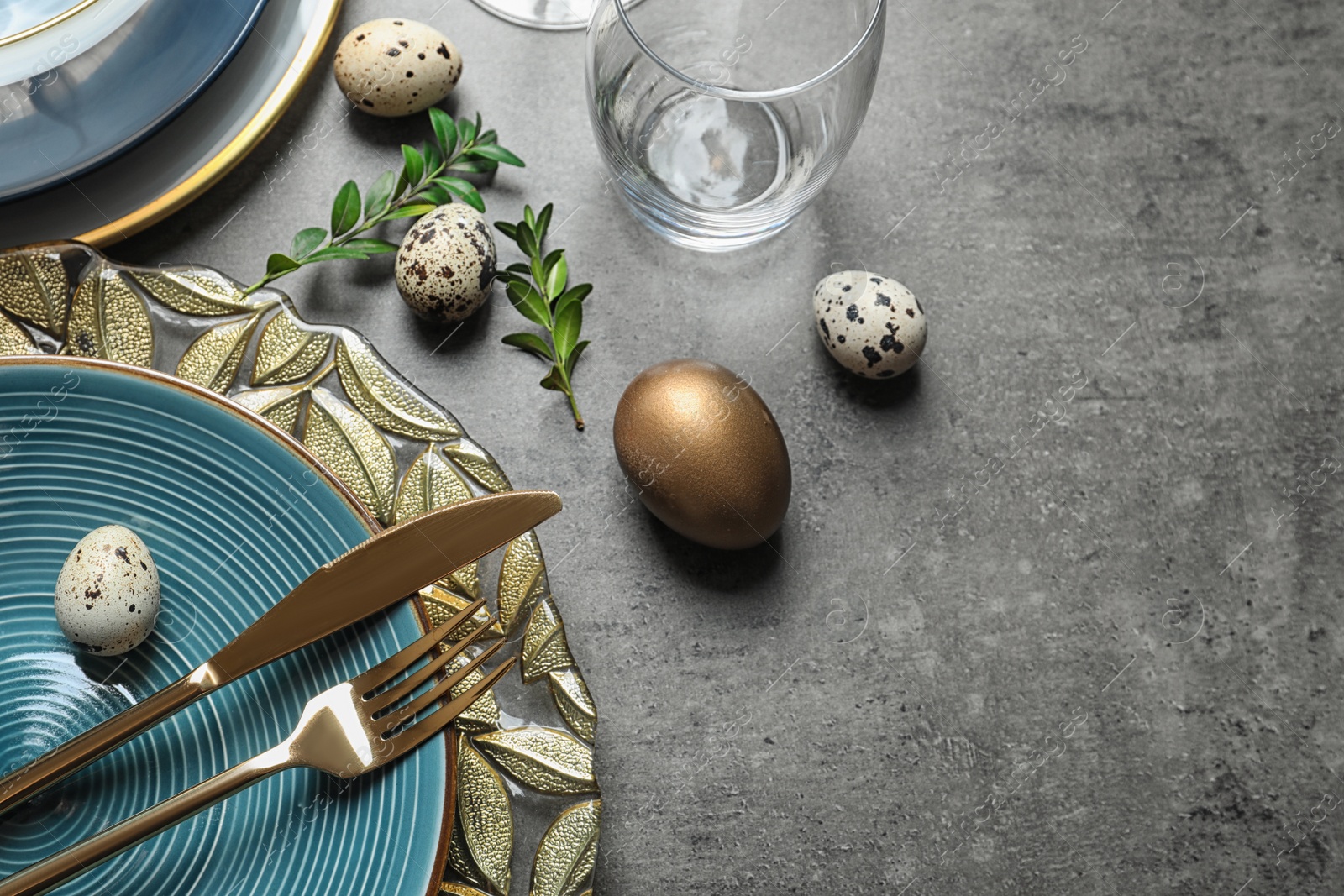 Photo of Festive Easter table setting with eggs on color background, above view. Space for text