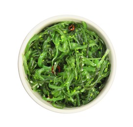 Photo of Japanese seaweed salad in bowl isolated on white, top view