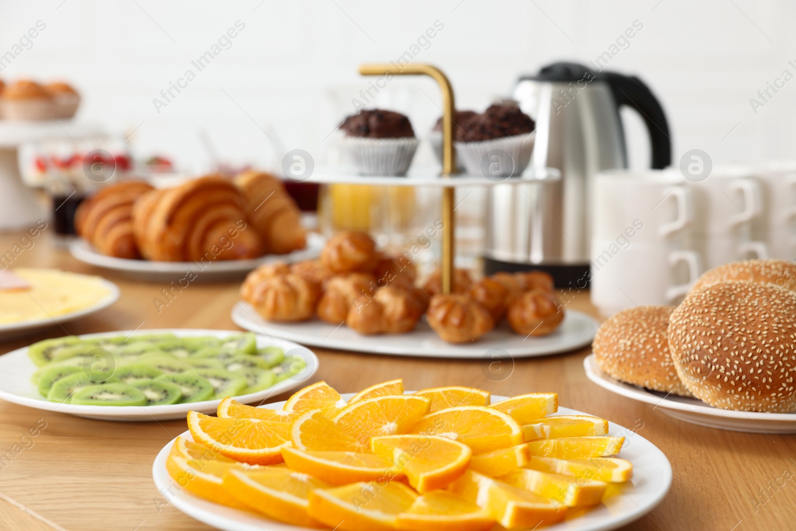 Photo of Different meals served on wooden table indoors, closeup. Buffet menu