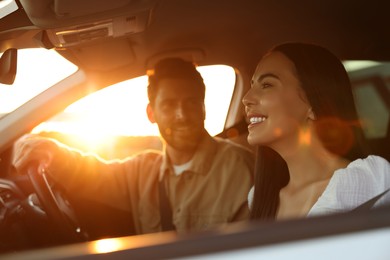 Happy couple enjoying trip together by car, selective focus