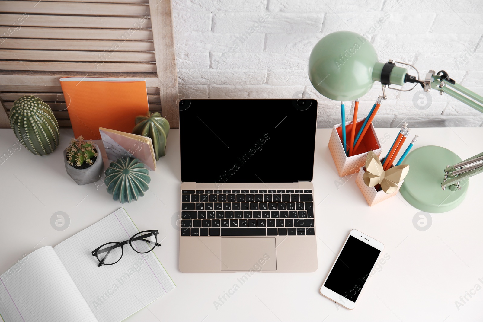 Photo of Modern workplace with laptop on table, above view. Mockup for design