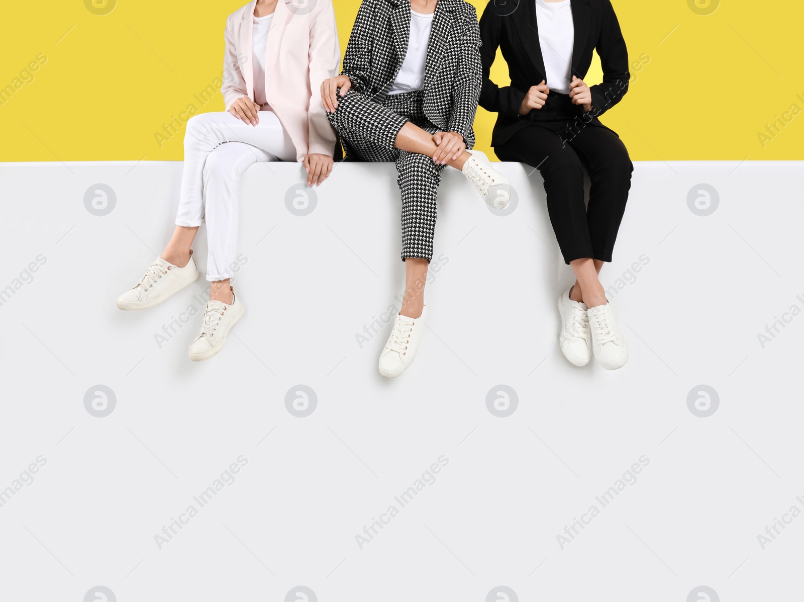 Photo of Women wearing stylish shoes on color background, closeup